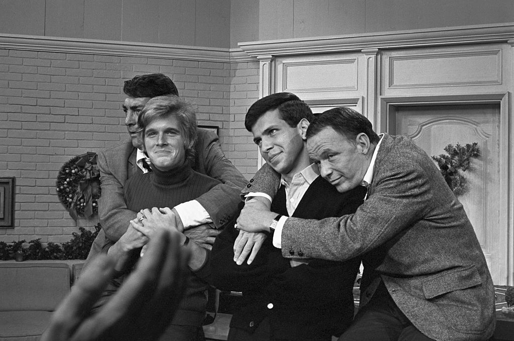Entertainers Dean Martin and Frank Sinatra with with their sons, Dean Paul Martin and Frank Sinatra Jr. on the set of 'The Dean Martin Show' Christmas special in 1967 in Los Angeles, California