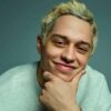 Pete Davidson smirks on a YouTube thumbnail, sitting against a blue background.