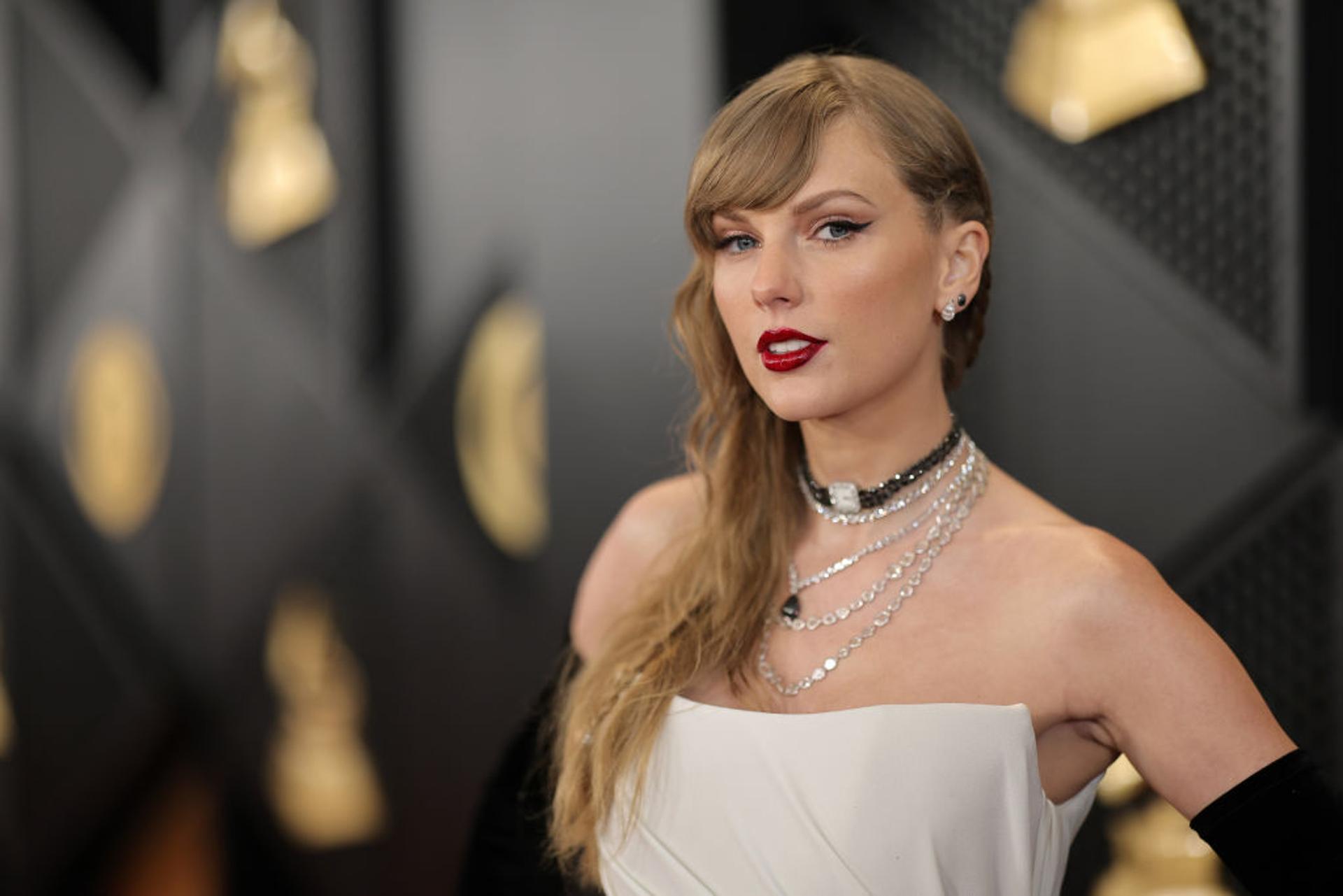 Taylor Swift pictured in a white dress at the 66th Grammy Awards