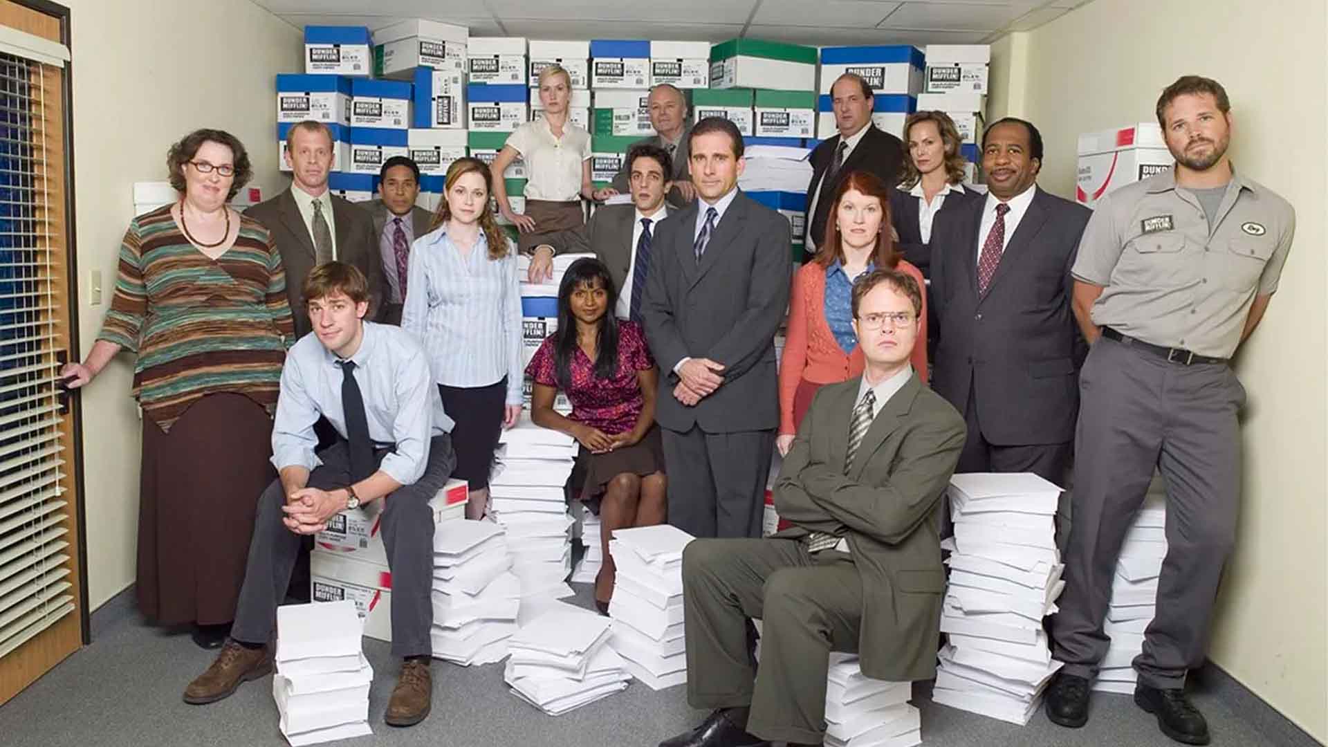 The cast of The Office around boxes of paper